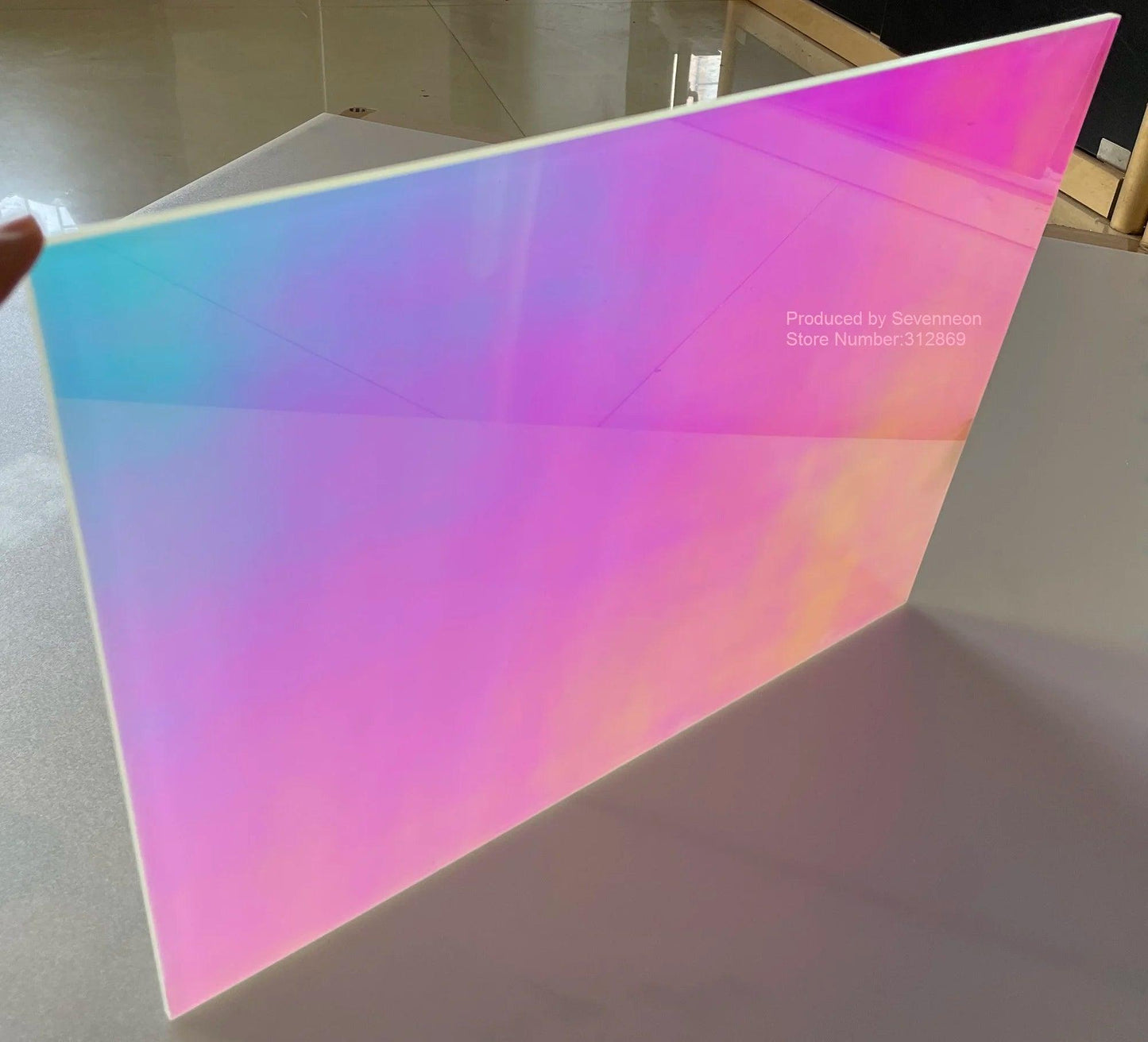 Angled shot of colorful rainbow acrylic PMMA sheet showcasing dazzling iridescent effect