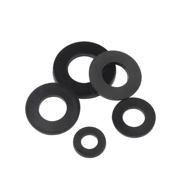 Close-up of white and black nylon flat washers in multiple sizes
