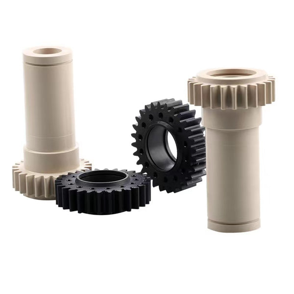 Precision CNC-machined plastic gears in black and beige cylindrical bushings in Nylon or PEEK for mechanical transmission and low-friction applications