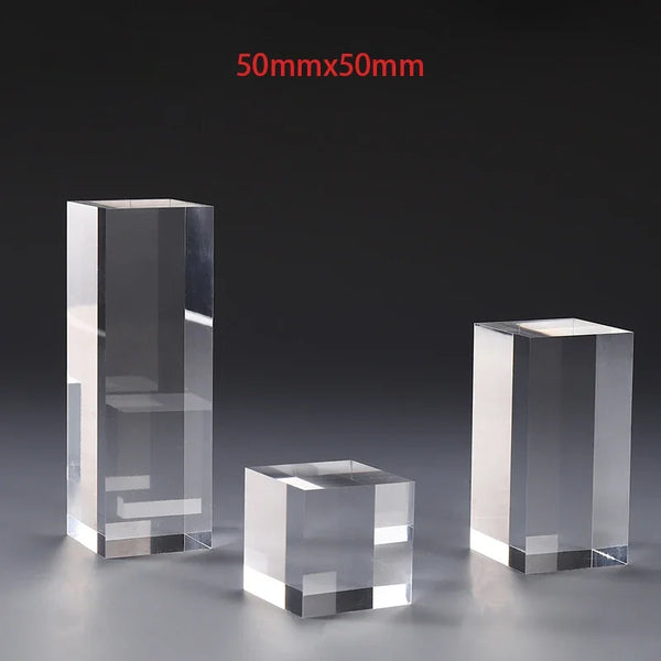Designer perfume bottle elevated on clear acrylic display stand