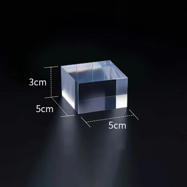 Multiple sizes of transparent acrylic cube risers showing scale comparison