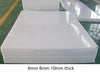 White UHMWPE plastic sheet stock on table