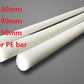 White 1 inch diameter HDPE plastic rod on a ruler